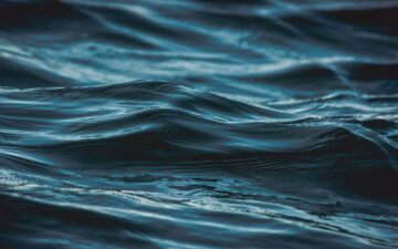 Dark blue ocean wave close up