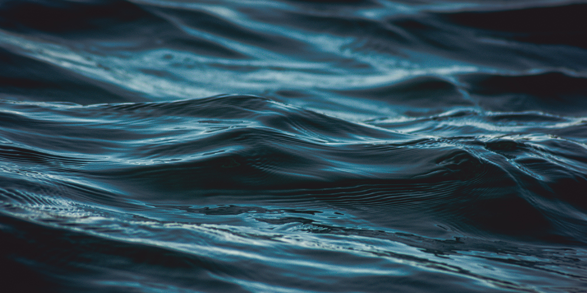 Dark blue ocean wave close up