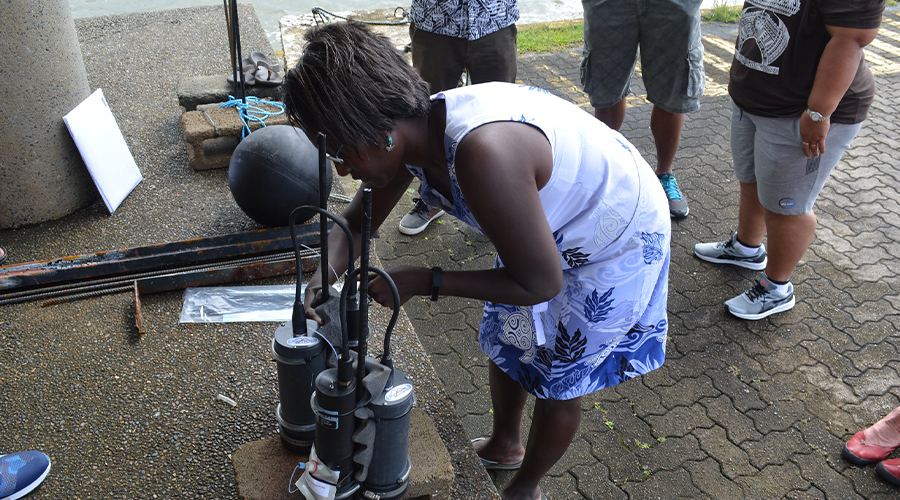 Scientist Katy Soapi adjusts the pH sensor before deployment