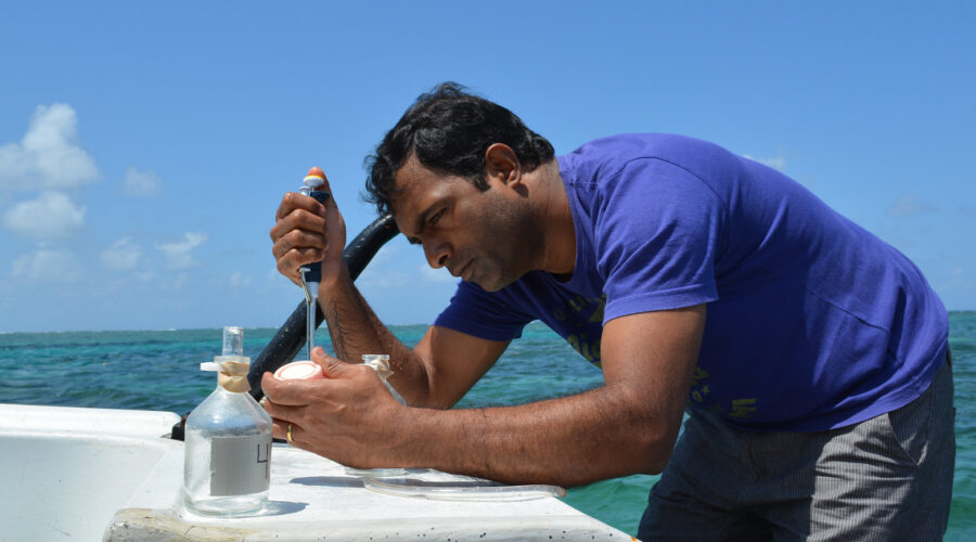 scientist on boat taking water samples