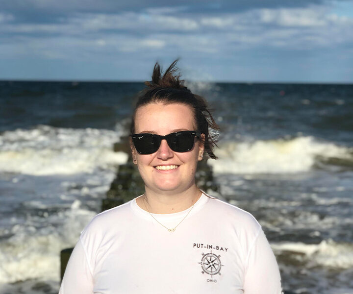 Photo of Courtnie Park standing on an old pier on a sunny day in the Atlantic Ocean in Delaware, USA