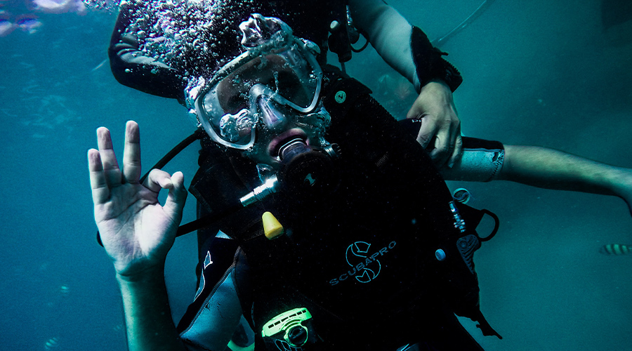 Scuba diver underwater giving O.K. sign