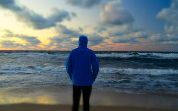 Person standing in front of ocean water