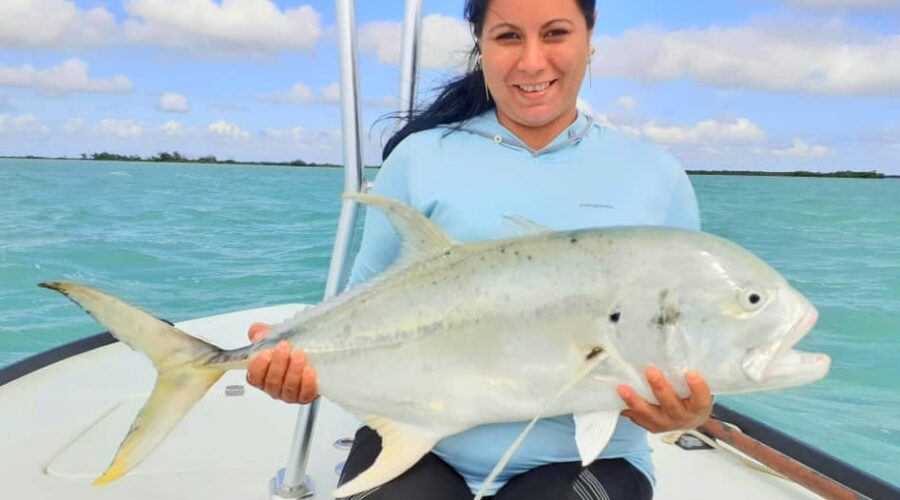 Woman holding large fish she caught