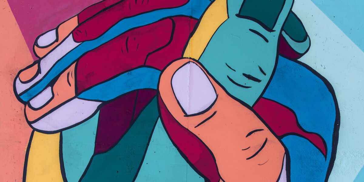 A colorful illustration of two clasping hands.