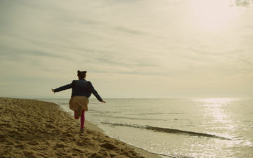 Childhood: little girl running along the coastline