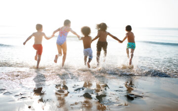 Banner for K-Love Interview: Group of kids enjoying their time at the beach