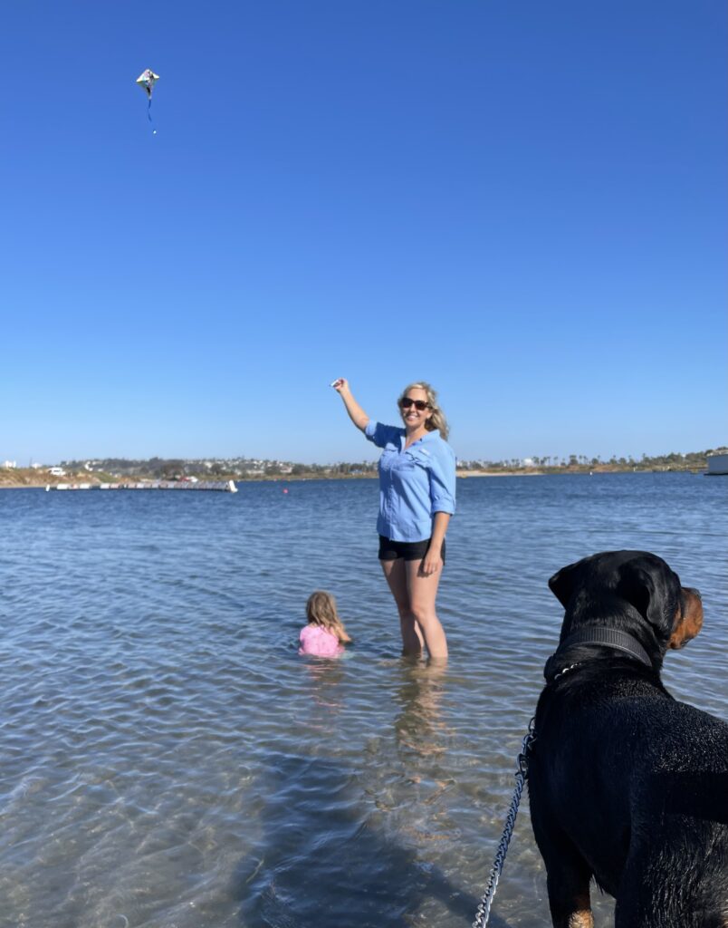 Frances with her daughter and dog in the water