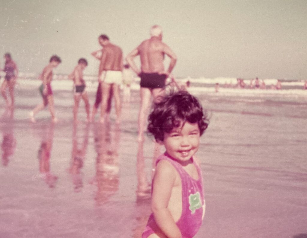 Andrea as a baby on the beach