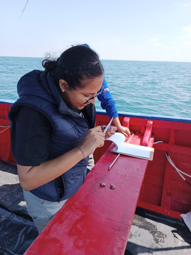 Woman taking a sample on a boat