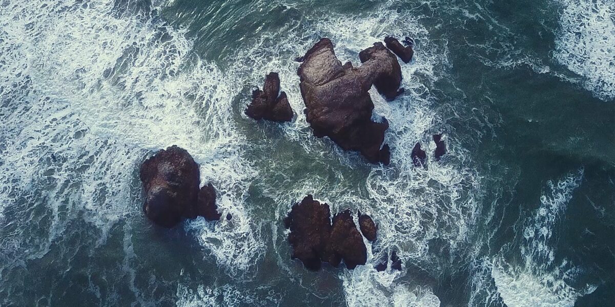 Ocean water splashing into rocks