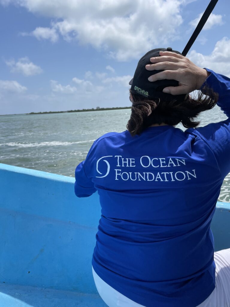 A person on a boat wearing a shirt that says The Ocean Foundation
