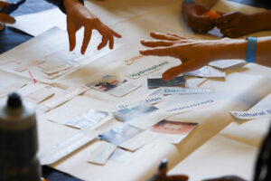 Educators Summit participants hands while working on an activity together