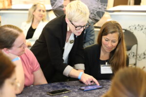 Carrie McDougall, Senior Program Manager at the NOAA Office of Education shows participants how to use the Science on a Sphere mobile app