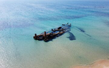 A photo of a shipwreck potentially leaking oil into the marine environment.