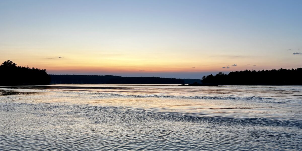 Summer sunset over water in Maine.